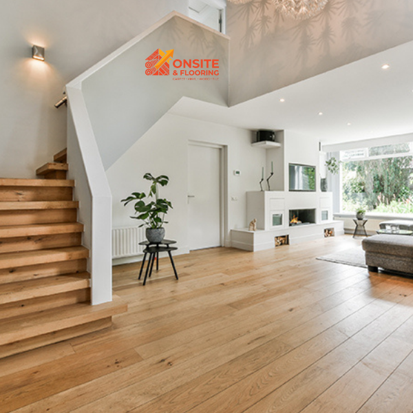 Modern home interior featuring warm natural hardwood flooring and staircase